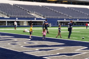 Xander, Maggie, Jason, and Kris in the end-zone at AT&T Stadium